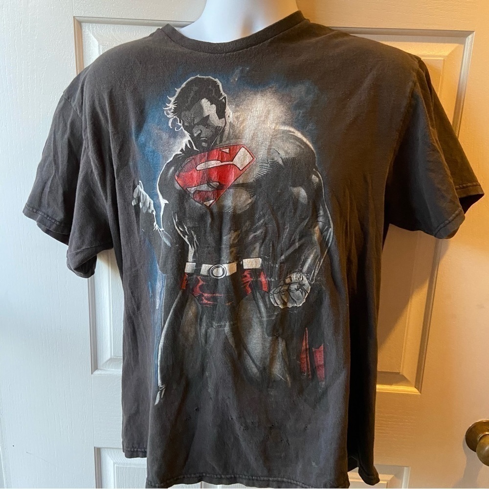 Superman T shirt features our Man Steel with clenched fist and jaw. Heroic!